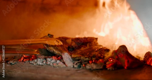Close up view of Prepare a steak from raw meat on a barbecue. photo