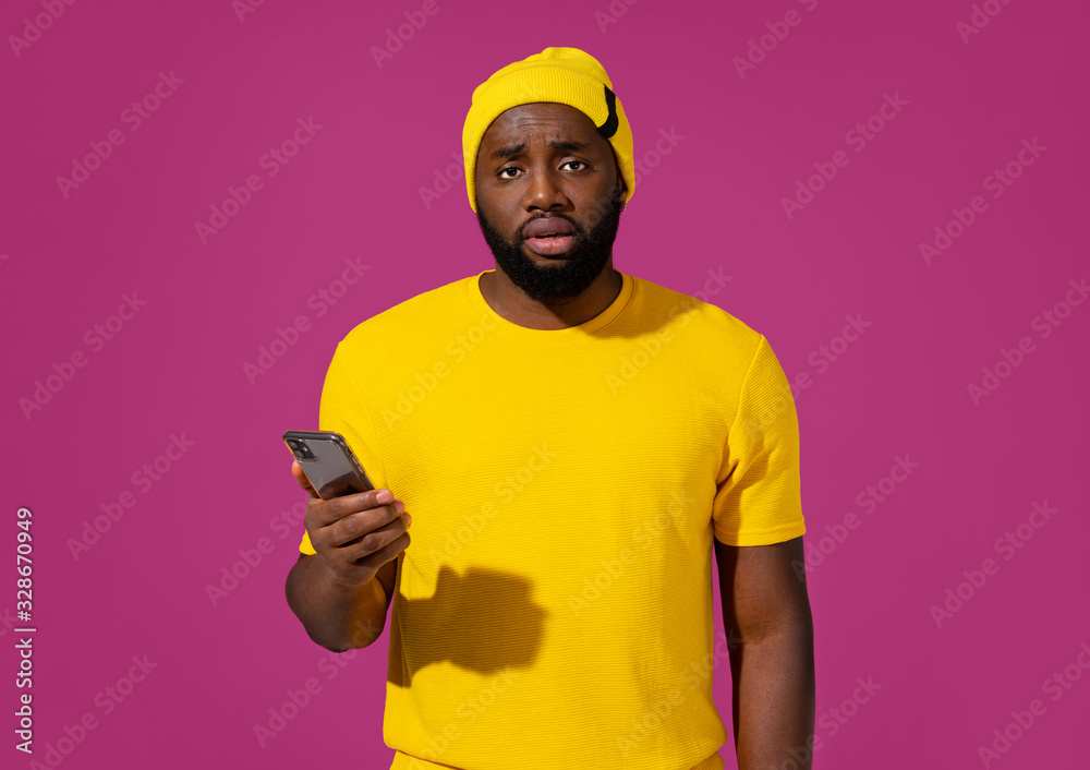 Sad man feeling upset after receiving message on purple background