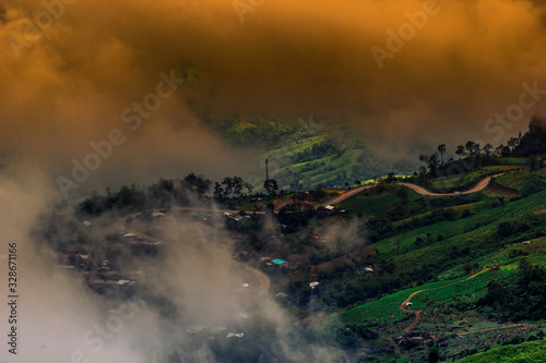 abstract background blur view of the sun shining through the clouds,surrounded by large mountains and various species of trees