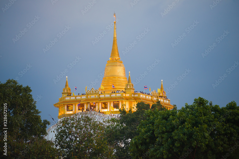 Naklejka premium Chedi of the Buddhist temple Wat Saket (Temple of the Golden Mountain) on evening twilight. Bangkok, Thailand