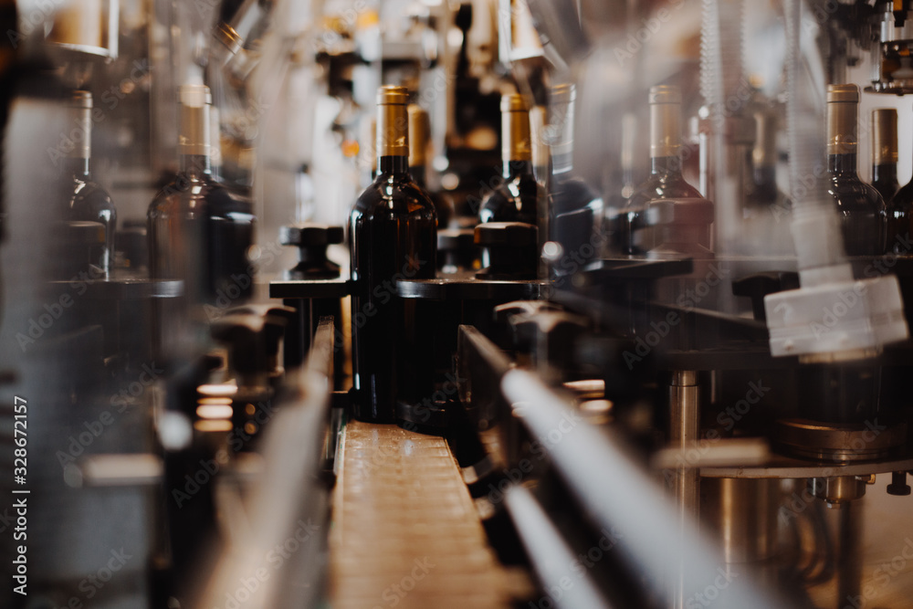 Fototapeta premium Industrial view bottle wine. Close up winery factory. 
