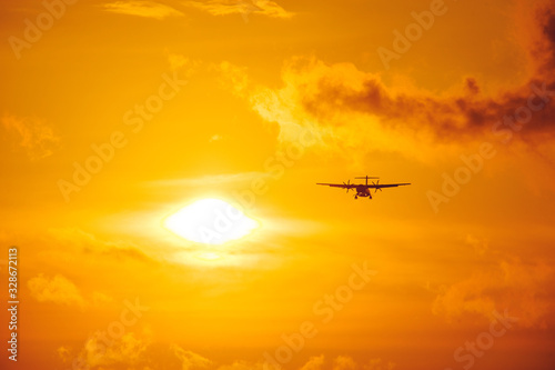 Silhouette of a passenger airliner in the sky during sunset. Airplane in the sky.