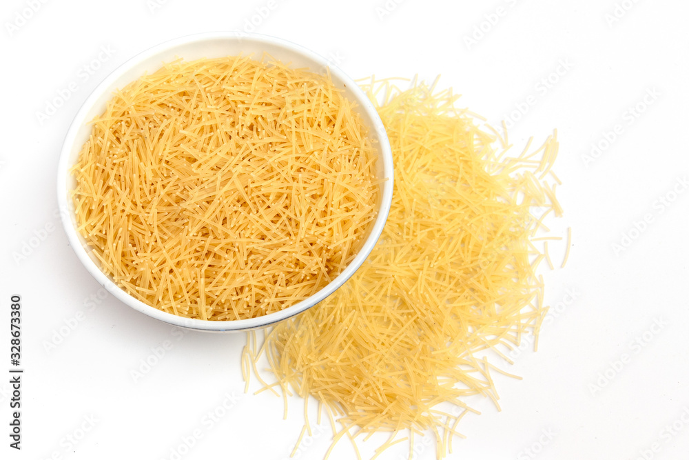 Vermicelli pasta in a wood bowl. white background, top view