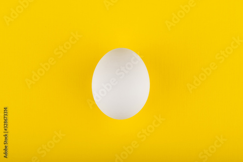 egg on yellow background top view