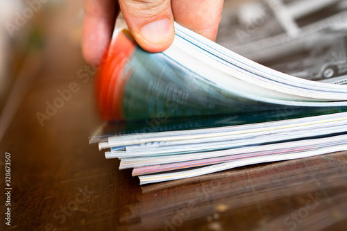 Closeup background of a pile of old magazines with bending pages photo