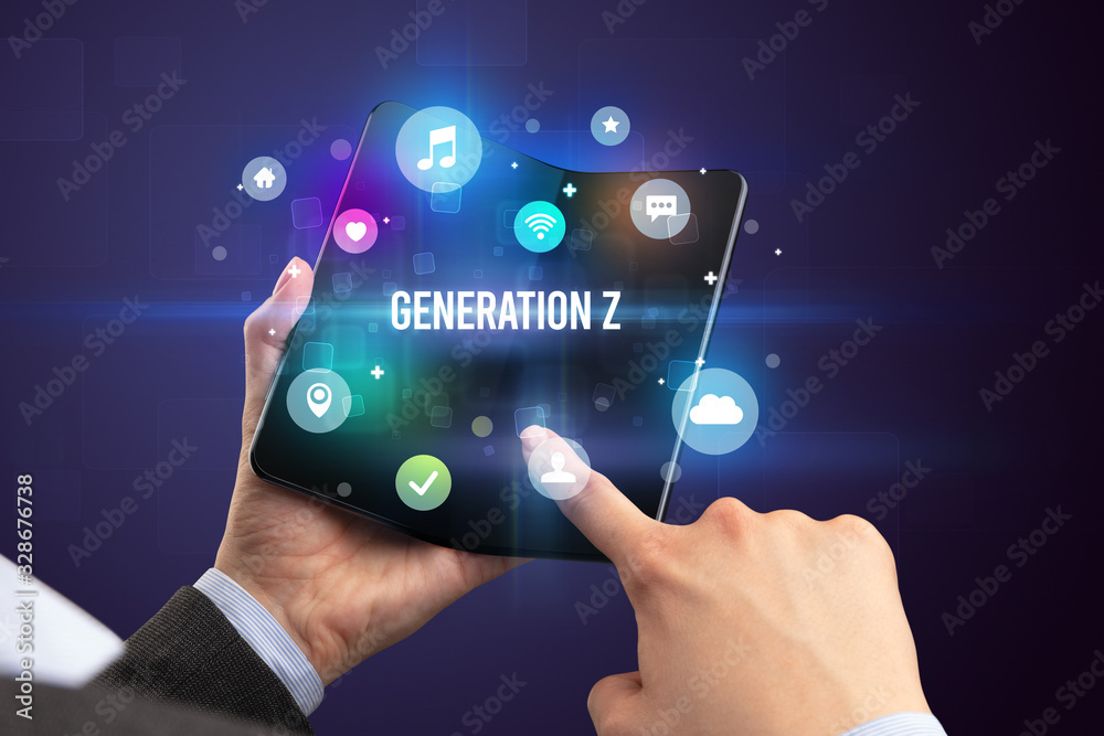 Businessman holding a foldable smartphone with GENERATION Z inscription, social media concept Businessman holding a foldable smartphone with GENERATION Z inscription, social media concept