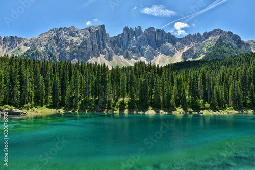 Scenic alpine image of fairy-tale lake surrounded by Dolomites in South Tyrol