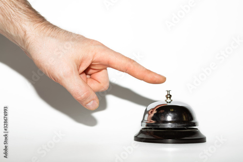 Hand ringing in service bell on a white background