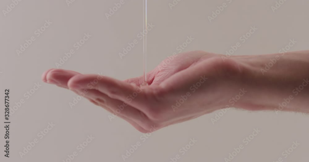Slow motion pour shower gel on man hand closeup
