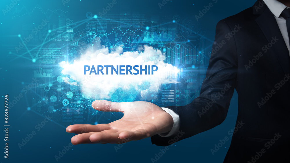 Hand of Businessman holding PARTNERSHIP inscription, successful business concept Hand of Businessman holding PARTNERSHIP inscription, successful business concept