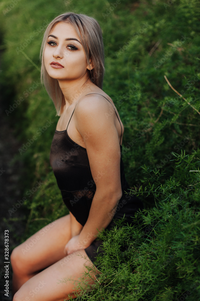Portrait of a young fashion model in a sexy top at tropical garden. Portrait of a young fashion model in a sexy top at tropical garden.