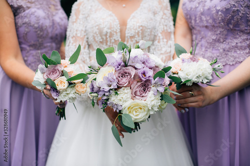 Bride and bridesmaids holding wedding bouquetes photo