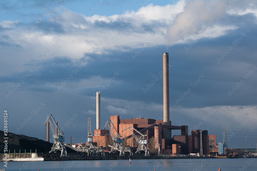 Factory in Helsinki on the shore with dramatic sky