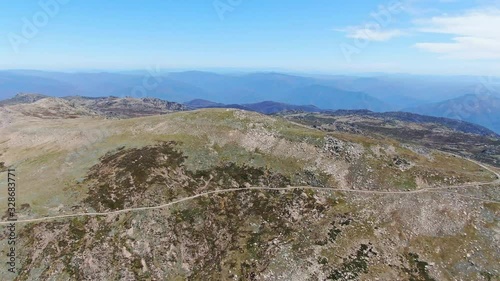 Stunning high angle aerial drone flight over the summit of Mount Kosciuszko (2228m above sea level) in the Snowy mountains, New South Wales, the hightest peak on the Australian continent. photo