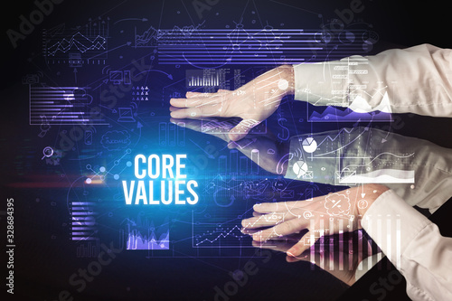 Businessman touching huge screen with CORE VALUES inscription, cyber business concept