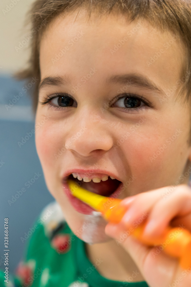 Happy little boy brushing his teeth. Oral hygiene concept. close up. vertical photo Happy little boy brushing his teeth. Oral hygiene concept. close up. vertical photo
