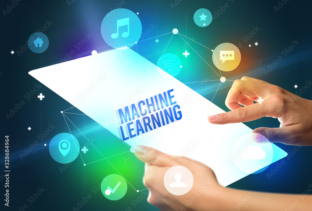 Holding futuristic tablet with MACHINE LEARNING inscription, new technology concept Holding futuristic tablet with MACHINE LEARNING inscription, new technology concept