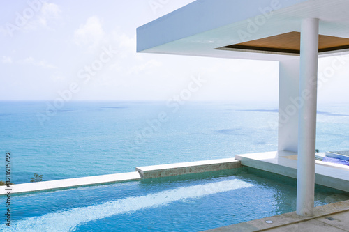 View of the villa and sea landscape with a blue pool in a minimalist style. Rich and luxurious life in the tropics of the island © Underwater girls