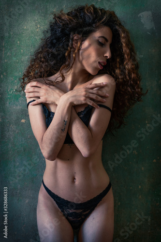 Curly hair girl fitness body in black bikini