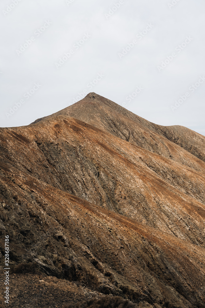 Desertic and arid mountains in Canary Islands with clean white sky
