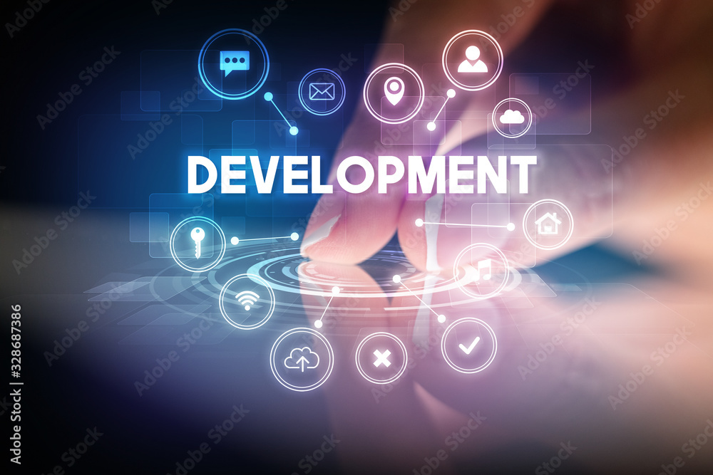 Finger touching tablet with web technology icons and DEVELOPMENT inscription, web technology concept Finger touching tablet with web technology icons and DEVELOPMENT inscription, web technology concept