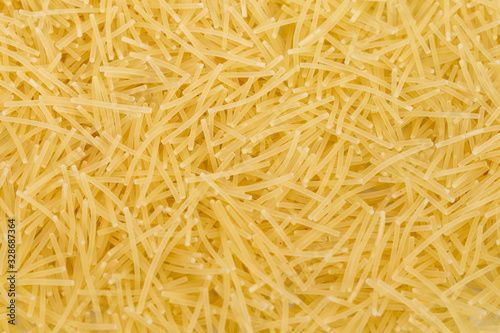 Raw vermicelli pasta (italian pasta) background, close up
