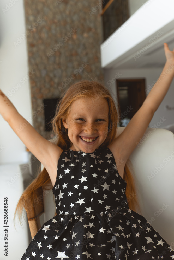Little girl with red hair shows different emotions. Sadness, joy and happiness. She smiles and cries. In a black dress with skin pigment on her face, freckles Little girl with red hair shows different emotions. Sadness, joy and happiness. She smiles and cries. In a black dress with skin pigment on her face, freckles