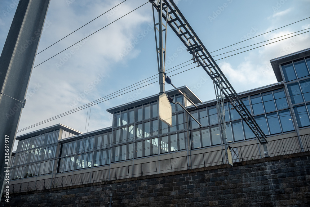 Small white empty sign on modern office building with glass exterior and cloudy sky background , copy space