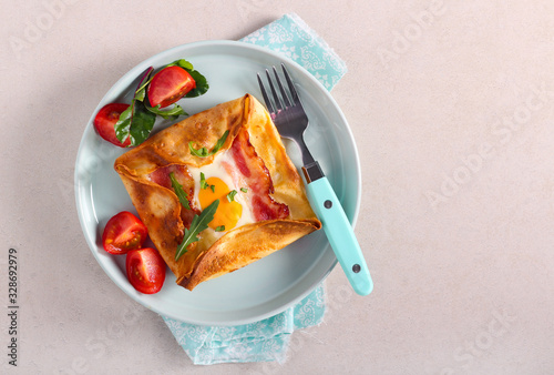 Egg, ham and cheese baked in a crepe