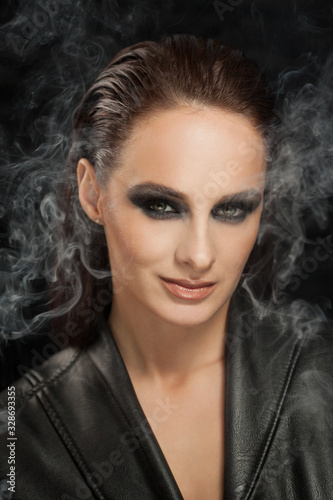 Closeup portrait of a serious lady with smoky eye makeup