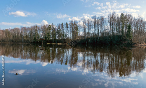 Fototapeta Naklejka Na Ścianę i Meble -  the view of the calm lake, the blue sky
