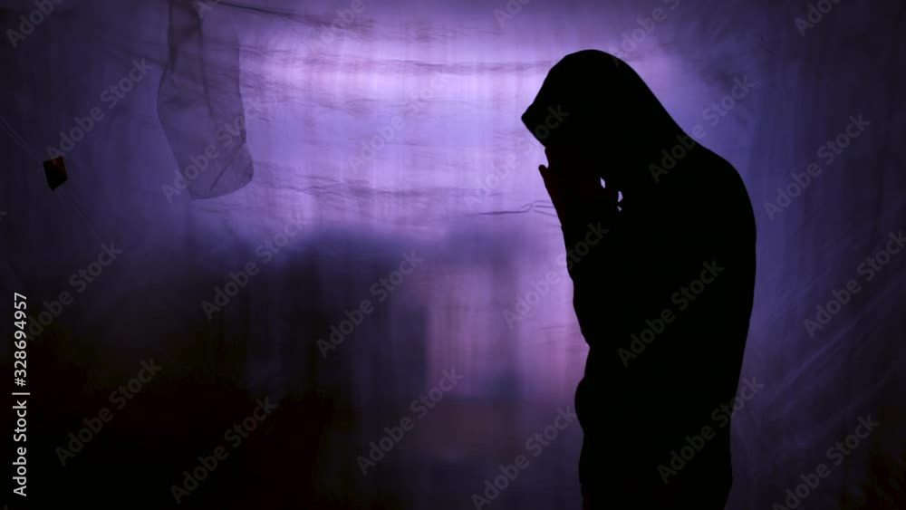 Hopelessness and despair, silhouette of hooded male figure
