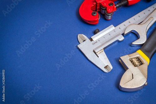 Set of tools on blue background prepared by professional master before repair or construction