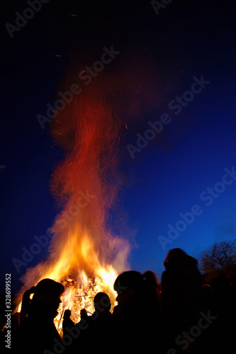 People standing in front of a traditional Easter fire in Germany