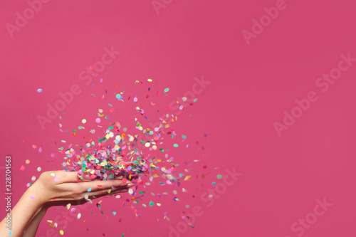 Fototapeta Falling confetti on bright pink background