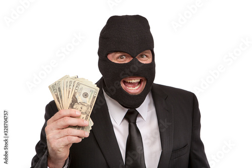 Criminal wearing a ski mask and holding cash in his hand on a white background.