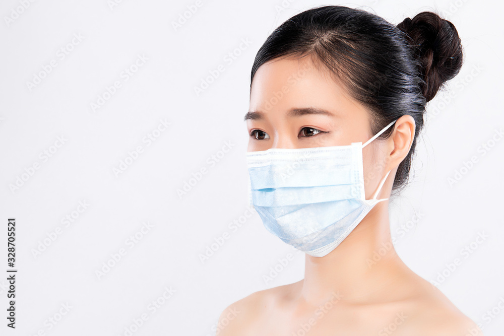 portrait of young woman wearing a face mask, isolated on white background. Flu epidemic, dust allergy, protection against virus. City air pollution concept portrait of young woman wearing a face mask, isolated on white background. Flu epidemic, dust allergy, protection against virus. City air pollution concept