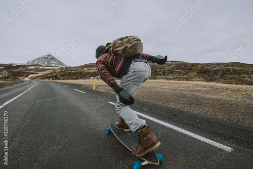 Skater traveling iceland on his longboard photo