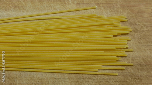 Close-up of Uncooked Spaghetti On A Scratched Wooden Board, Top View
