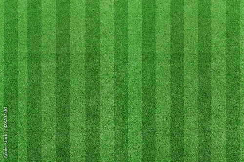 Top view stripe grass soccer field. Green lawn pattern background