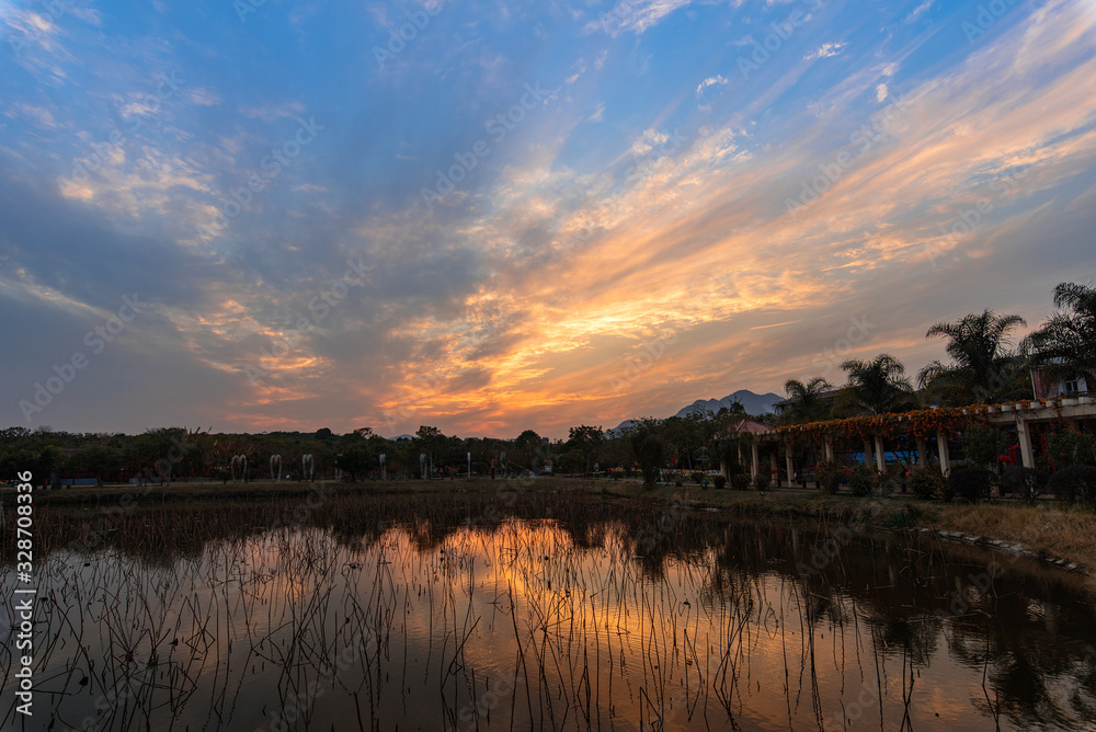 Fototapeta premium The lake under the setting sun reflects the sunset
