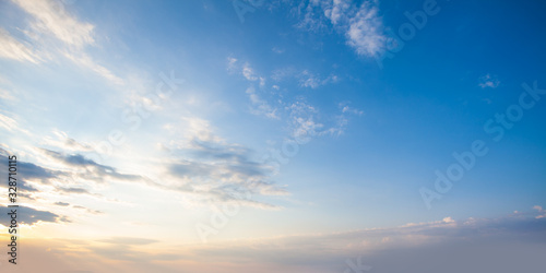 Fototapeta Naklejka Na Ścianę i Meble -  Blue sky clouds background. Beautiful landscape with clouds and orange sun on sky