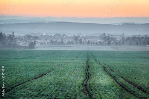 City around field and sunrise.
