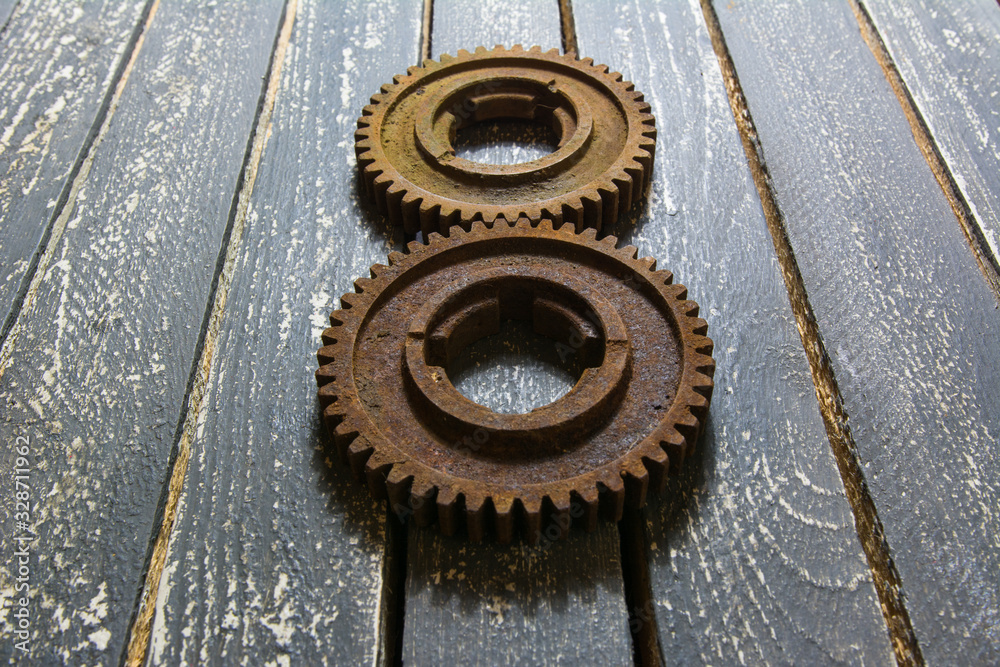 Old rusty gears on a wooden table set in the shape of number eight. Old rusty gears on a wooden table set in the shape of number eight.