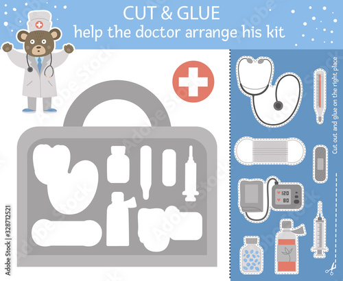 Vector medical cut and glue for children. Medicine educational activity with cute doctor bear and first aid kit with equipment. Help the doc arrange his bag..
