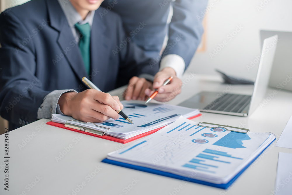 Business people discussion and summary financial information at meeting. Business people discussion and summary financial information at meeting.