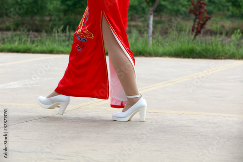 red cheongsam ladies in the park