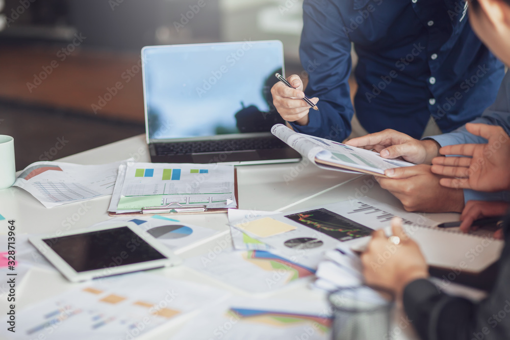 Group of business people working together on new project with planning analytical report at meeting.. Group of business people working together on new project with planning analytical report at meeting..