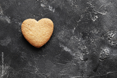 Delicious homemade cookie hearts on a dark background. Top view. Place for text.