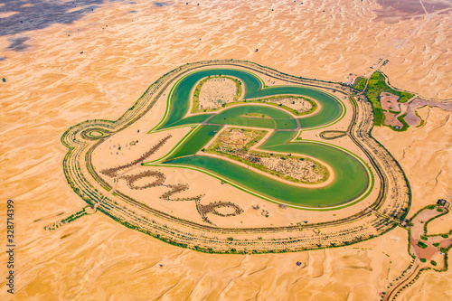 Fototapeta Naklejka Na Ścianę i Meble -  Aerial top view of love lake and sand desert, Heart shaped lakes in Al Qudra in Dubai, United Arab Emirates or UAE.  A new tourist destination for valentine day. Natural landscape background